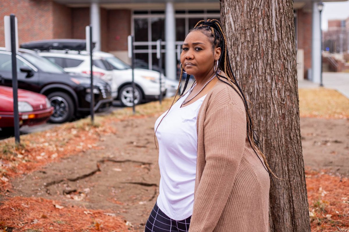 Neshia Greene poses near the sinkhole she said she fell into in Decemeber.