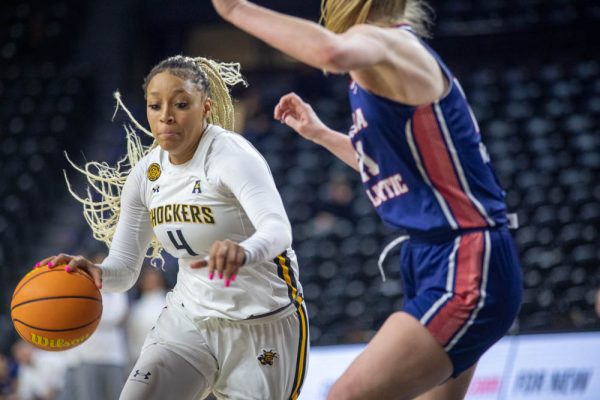 Junior forward Jayla Murray drives the ball on Feb. 5. Murray contributed 18 points during the game against Florida Atlantic, leading the Shockers.