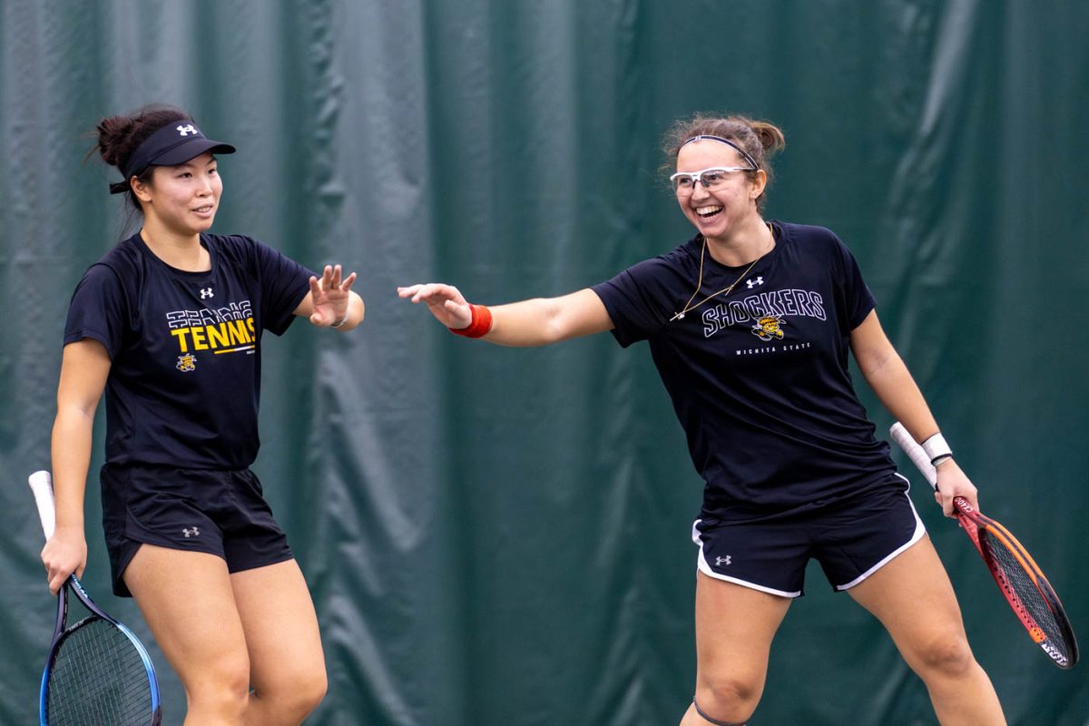 Wichita State women's tennis players Xin Tong Wang, left, and Giorgia Roselli high-five during a doubles match against Kentucky on Feb. 7, 2025. (File photo)