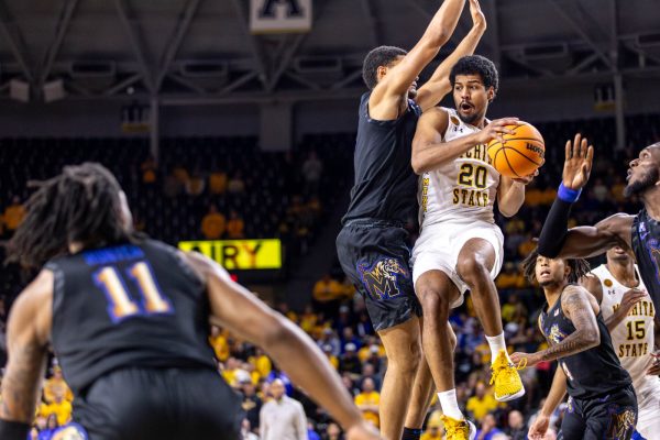 Harlond Beverly jumps to pass the ball to a teammate in the second half on Sunday afternoon. Beverly had a statline of 11 points, three rebounds, and six assists.