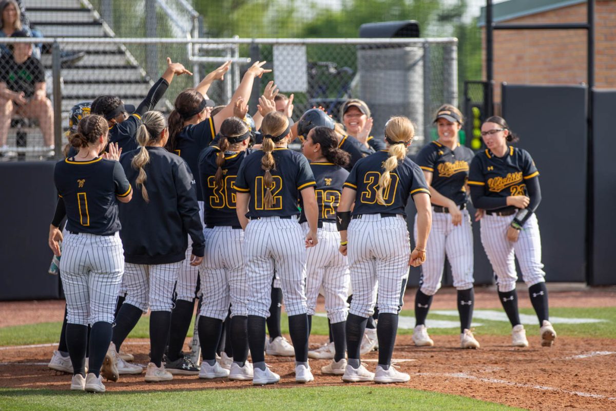 The Wichita State softball team cheers after a home run on April 26 against the University of North Texas. (File photo)