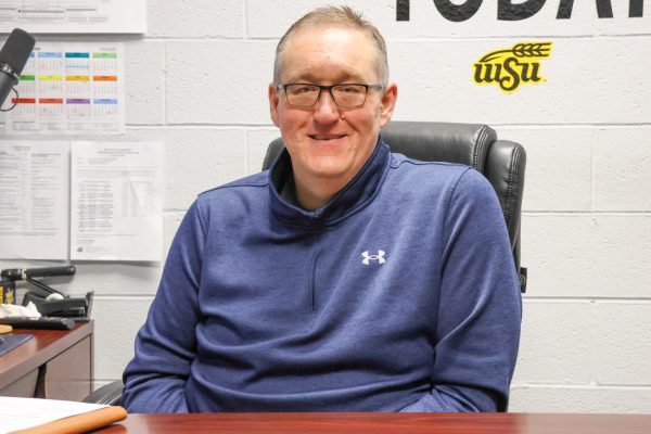 Mike Ross poses for a photo in his Department of Sport Management office. Ross' office can be found in room 221, Hubbard Hall.