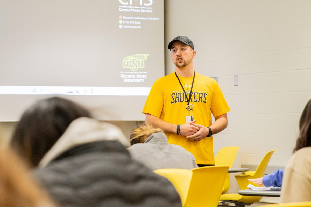 Adjunct instructor Remington Putter explains his snowball throwing activity, where students wrote on a piece of paper, crumpled it up, and then threw it across the room. The activity was meant to teach students how they could incorporate fun learning into their future classrooms.