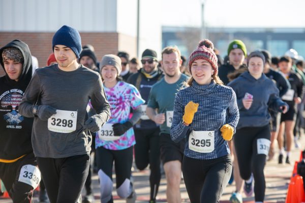 Participants of the Wichita State Engineering 5k Run/Walk take off outside of the John Bardo Center. The 5k took runners around campus — from Shocker Hall to Hyatt Place — during the annual event.