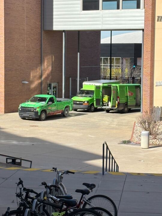 Trucks outside of Shocker Hall on Feb. 3. A water damage and restoration company has been hired to restore the flooded floor, according to Housing and Residence Life.