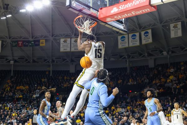 Senior center Quincy Ballard throws down a backwards dunk in the second half against Tulane. Ballard finished the game with 11 points.