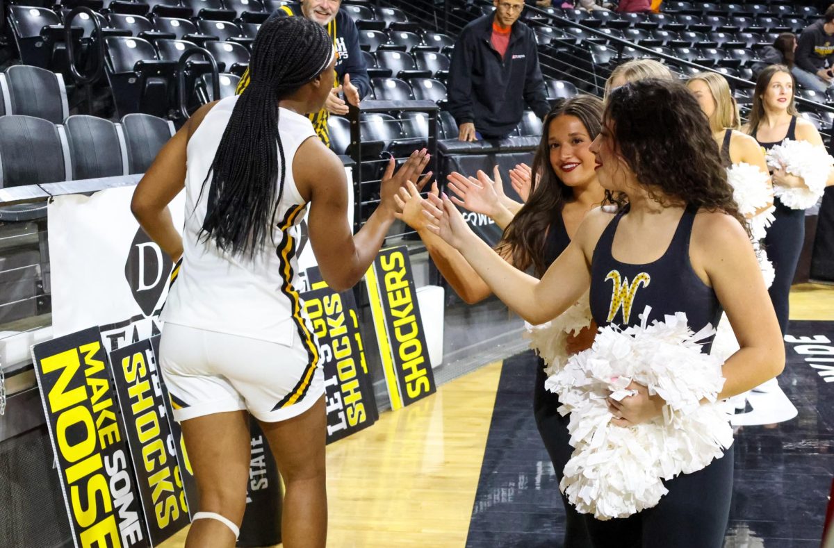 Junior forward Bre'Yon White high-fives members of the dance team. White scored six points in the 60-57 win against Rice University.