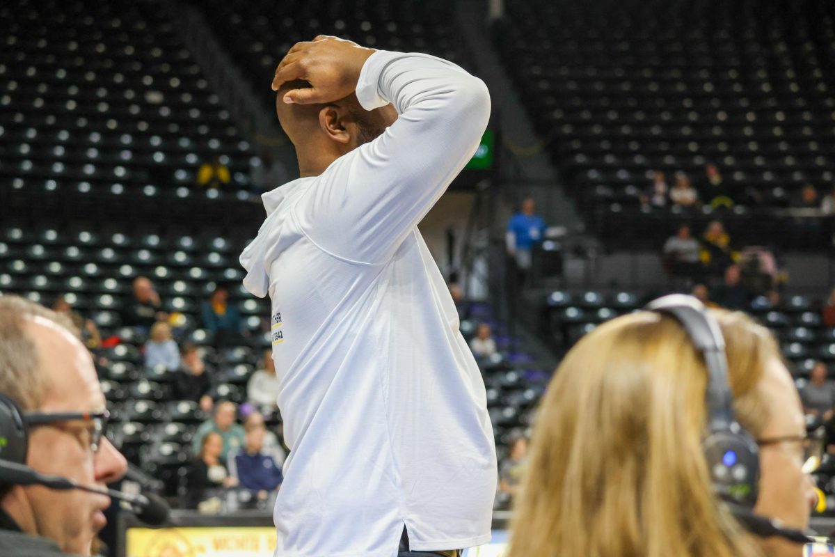 WSU women's basketball head coach Terry Nooner puts his hands on his head in shock on Feb. 15. The Shockers committed 11 turnovers and 15 fouls, but beat Rice.