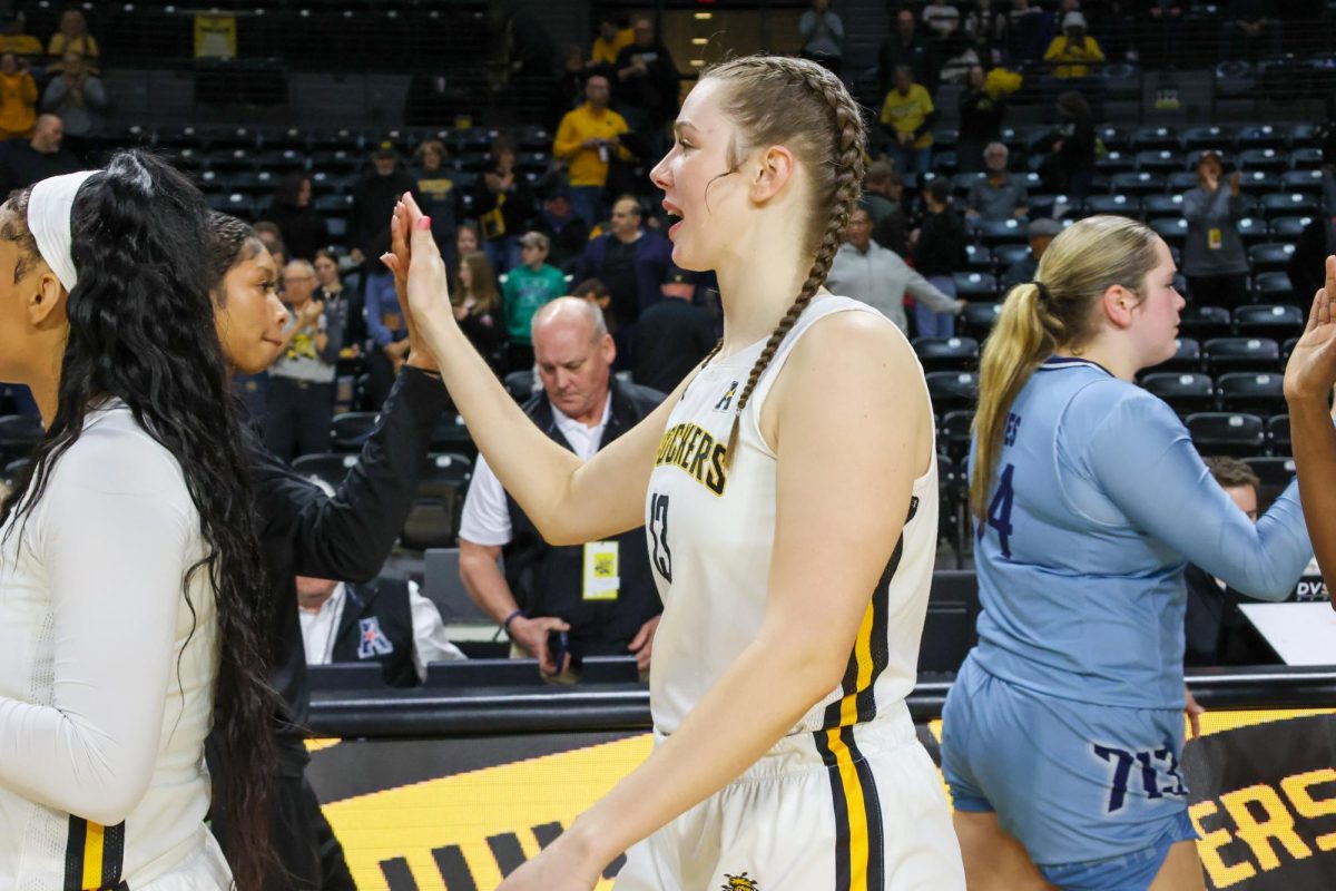 Senior center Ella Anciaux high-fives players from Rice University after the game on Feb. 15. Anciaux finished the game with two rebounds.