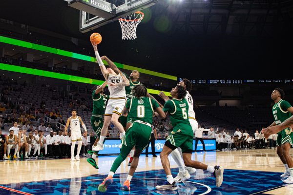 Senior Bijan Cortes drives through the South Florida defense for a layup late in the second half on March 13. Cortes finished the game with 20 points and seven assists with no turnovers.