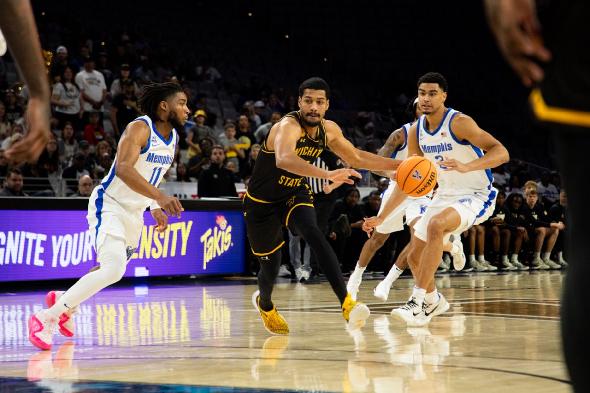 Senior Harlond Beverly sprints past two Memphis defenders to bring the ball down the court on March 14. The Shockers' loss against Memphis eliminated them from the AAC Championship in the quarterfinals.