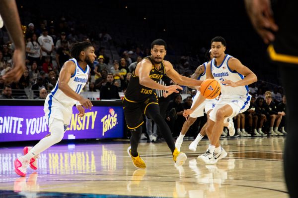 Senior Harlond Beverly sprints past two Memphis defenders to bring the ball down the court on March 14. The Shockers' loss against Memphis eliminated them from the AAC Championship in the quarterfinals.