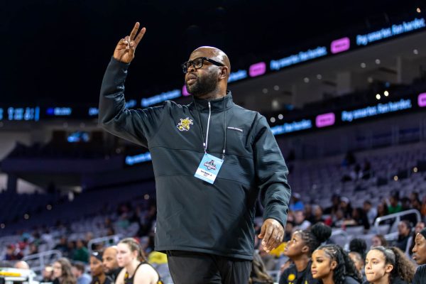 WSU head coach Terry Nooner signals the next play to the Shockers. Nooner is in his second season with Wichita State.
