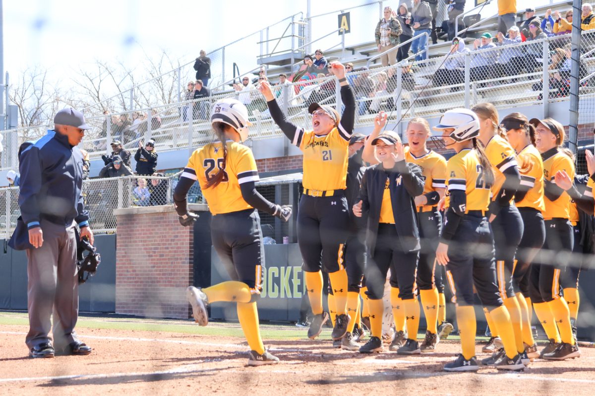 The WSU softball team celebrates a home run by Lauren Lucas, welcoming her to home plate. The Shockers hit a total of three home runs on Sunday, March 16, against North Texas.