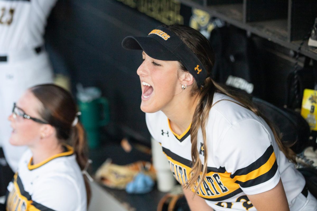 Junior Taylor Sedlacek cheers on her teammates during the softball game against South Florida on March 28. The Shockers won the first game of the three-game series, 9-4.