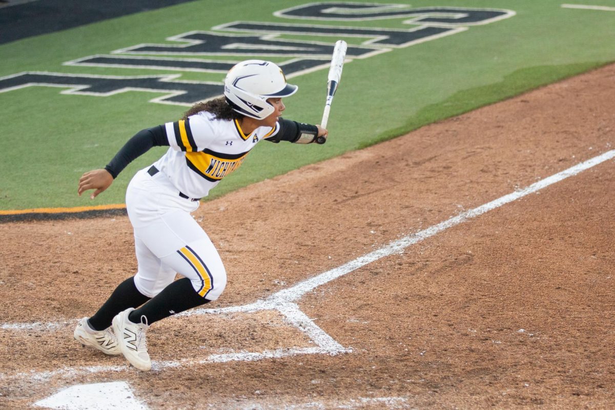 Freshman Gabby Scott prepares to release the bat after hitting the ball into the field during a game against South Florida.