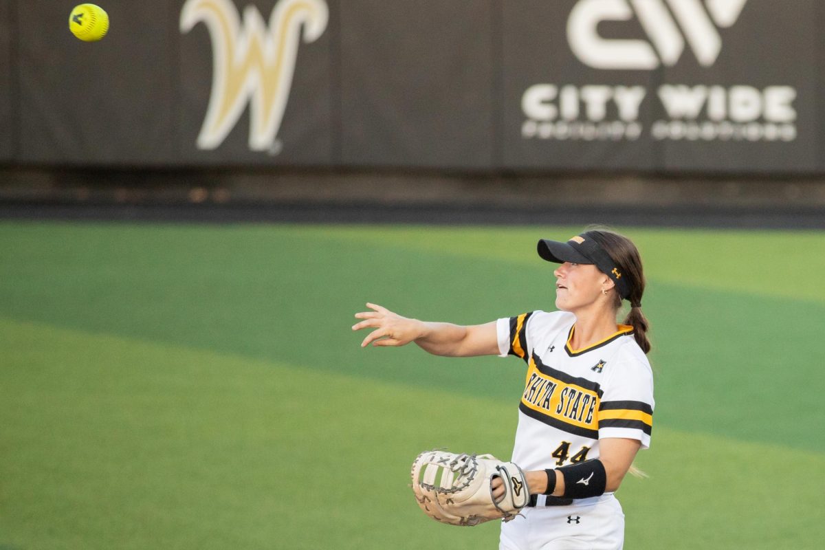 Senior Camryn Compton throws the ball to the pitcher during the game against South Florida on March 28. The Shockers won 9-4.