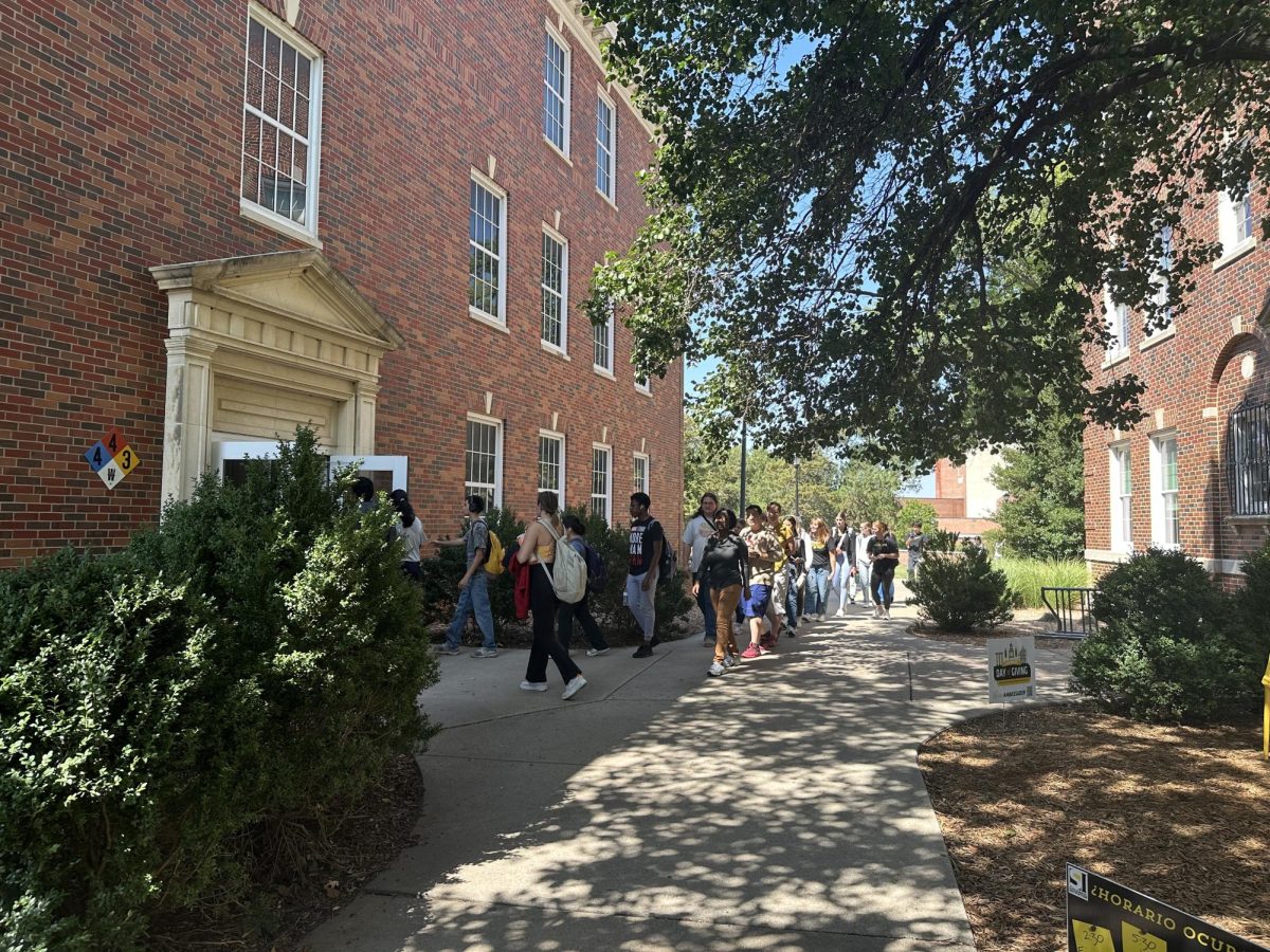 Students enter a building on Wichita State's campus. Over the 2025 spring break, fire alarms and sprinklers on the campus will be tested.