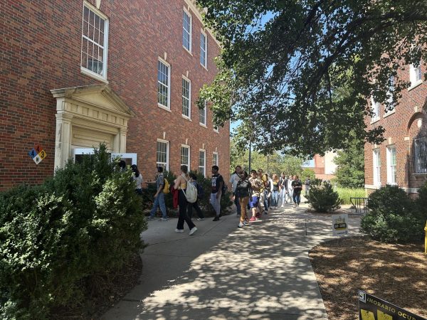 Students enter a building on Wichita State's Campus. Over the 2025 spring break, fire alarms and sprinklers on the campus will be tested.