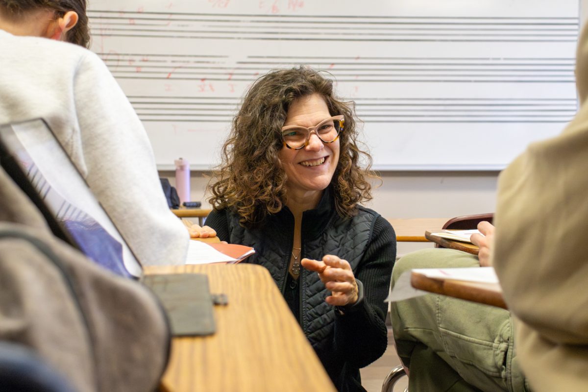 Program Director of the Master of Arts in Arts Leadership and Management provides advice to a group of students as they work on a composition project. Through her position, Banke trains and develops the next generation of musical artisits.