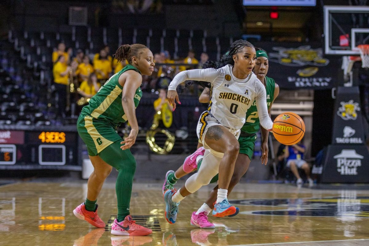 Taylor Jameson runs with ball against Charlotte on March 1. The game ended with the score of 62-43, a Wichita State win.