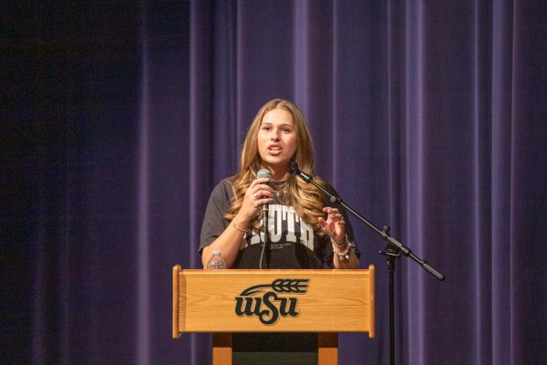 Olivia Crolczyk, Riley Gaines Center ambassador, speaks in fron of an audience at Wichita State on March 11. The event was hosted by WSU's chapter of Turning Point USA.