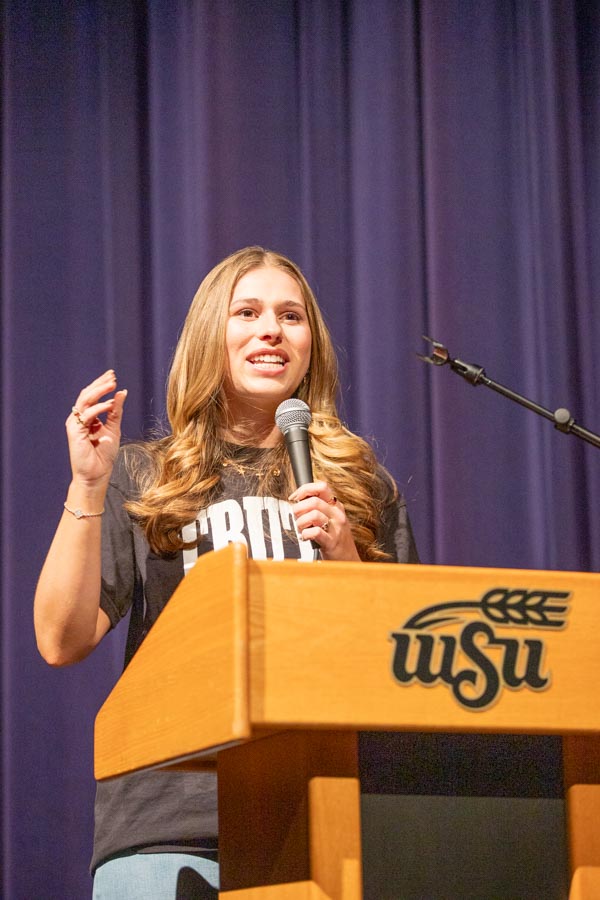 Olivia Crolczyk, Riley Gaines Center ambassador, speaks in fron of an audience at Wichita State on March 11. The event was hosted by WSU's chapter of Turning Point USA.