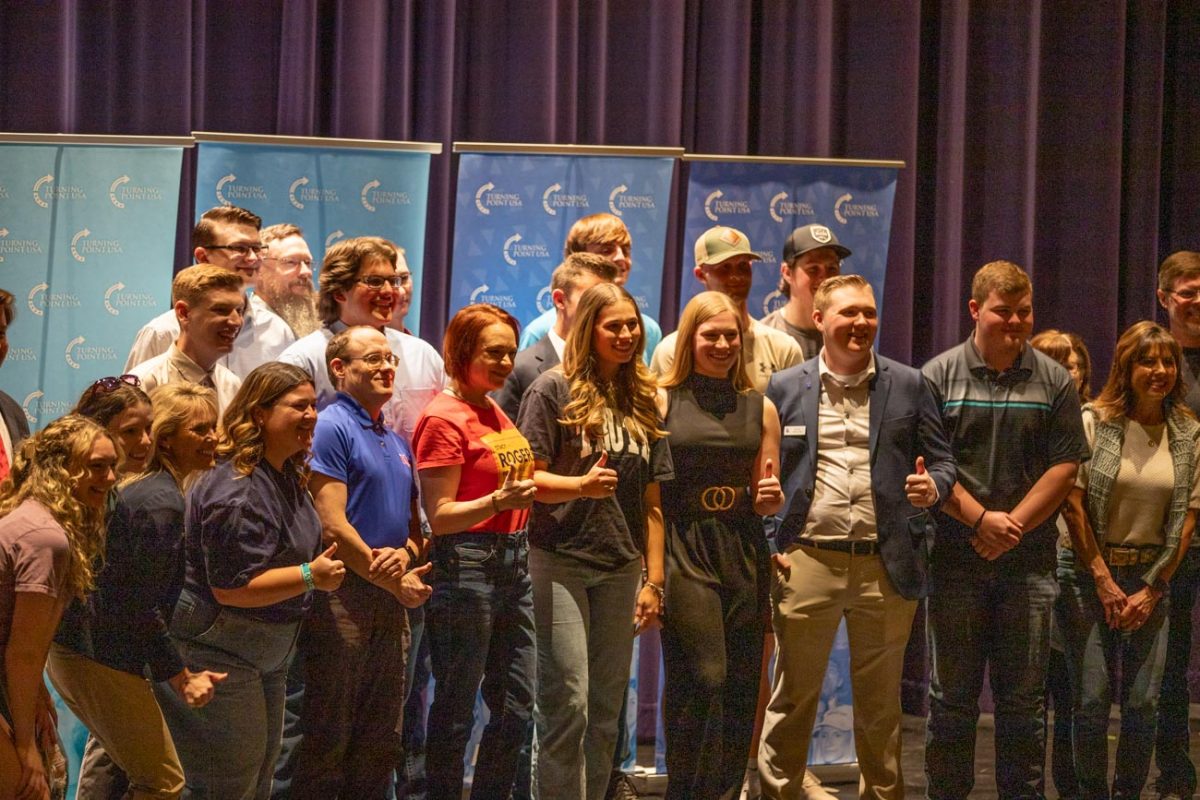 Members of the TPUSA audience take a group photo with Olivia Krolczyk. Krolczykadvocates for free speech and is part of the Riley Gaines Center, an organization aimed at combating "radical leftist ideology."