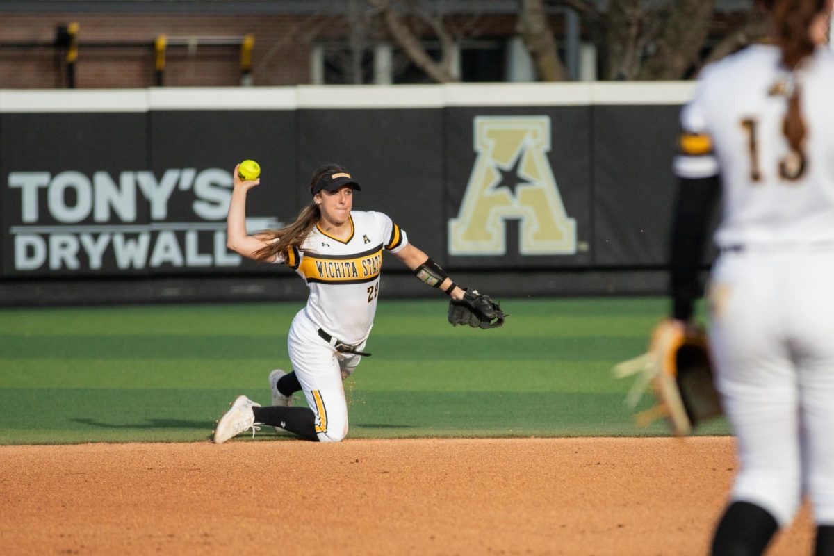 Junior Taylor Sedlacek throws the ball toward first base in attempt to get out a South Florida player on March 28.