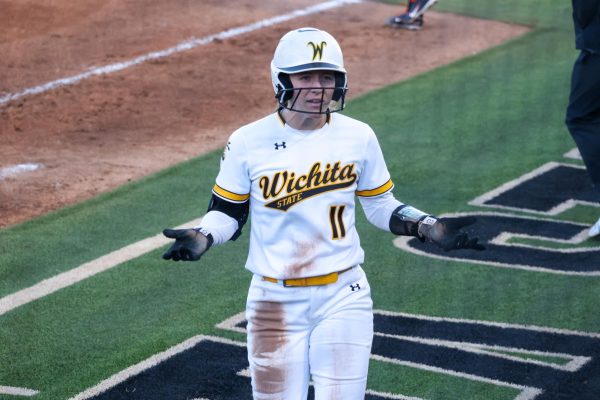 Graduate student Ellee Eck shrugs her shoulders after she fouled out to second on Feb. 27. Eck hit 2-3 from the plate against Oklahoma State University.