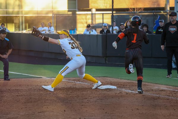 Senior Caroline Tallent stretches to try and make an out against Oklahoma State University. Wichita State did not commit an error in the 11-2 loss against the Cowgirls on Feb. 27.