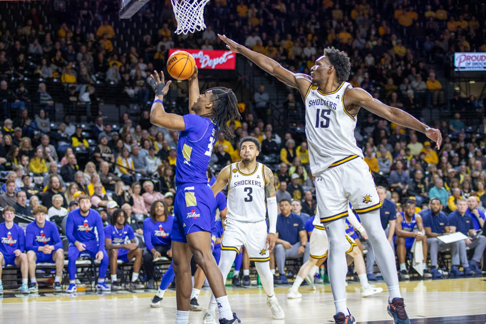 Senior center Quincy Ballard attempts to block a basket by a Tulsa player. Ballard contributed four points and 13 rebounds during the March 9 game.