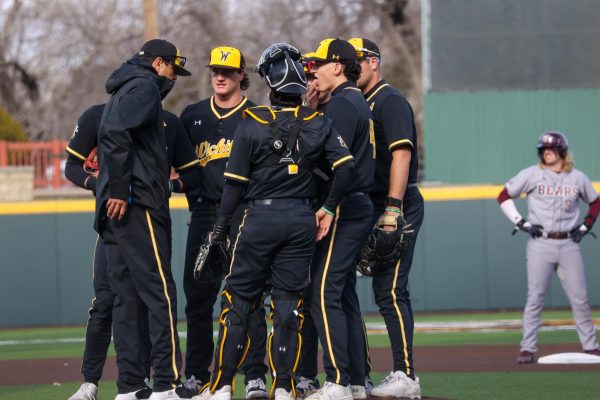 WSU Pitching coach Anthony Claggett meets the team on the mound during the game on March 7. The Shockers pitching allowed five runs in the 7-5 win.