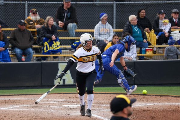 Graduate student Ellee Eck tosses her bat after she is walked against South Dakota State University. The Shockers were walked seven times in the 6-4 loss.