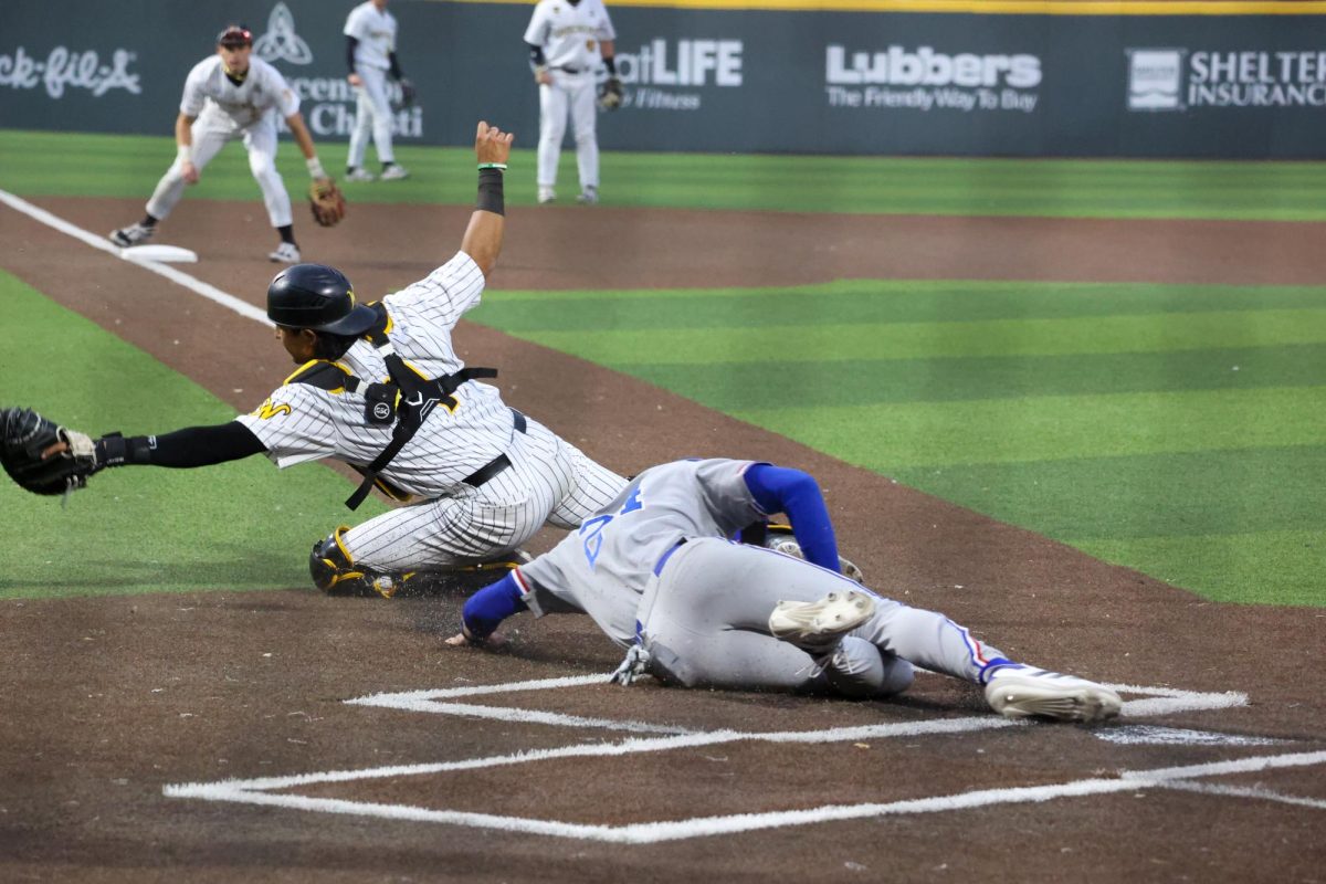 Senior Mauricio Millan unsuccessfully tries to tag out a Bulldogs runner. Louisiana Tech beat the Shockers, 27-12, on March 14.