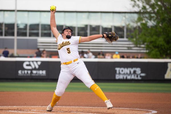 Freshman Ava Sliger prepares to pitch the ball during a game against the University of Kansas. The Shockers pulled up short of the Jayhawks, 5-3.