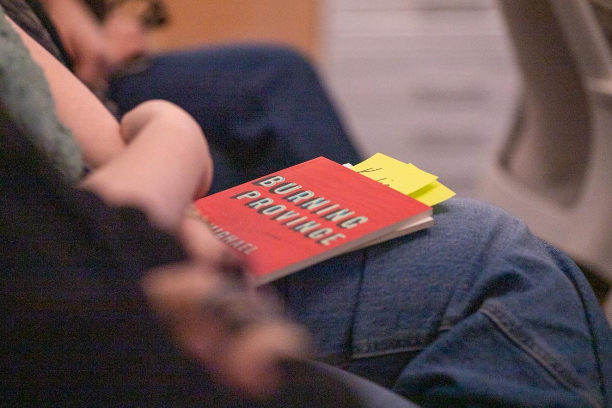 Michael Prior's book, Burning Province held by an attendee of Prior's poetry reading event.