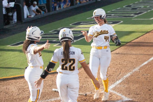 Senior Camryn Compton greets her teammates after hitting a home run against the University of Kansas on April 30. Compton hit 1-5 in the loss.