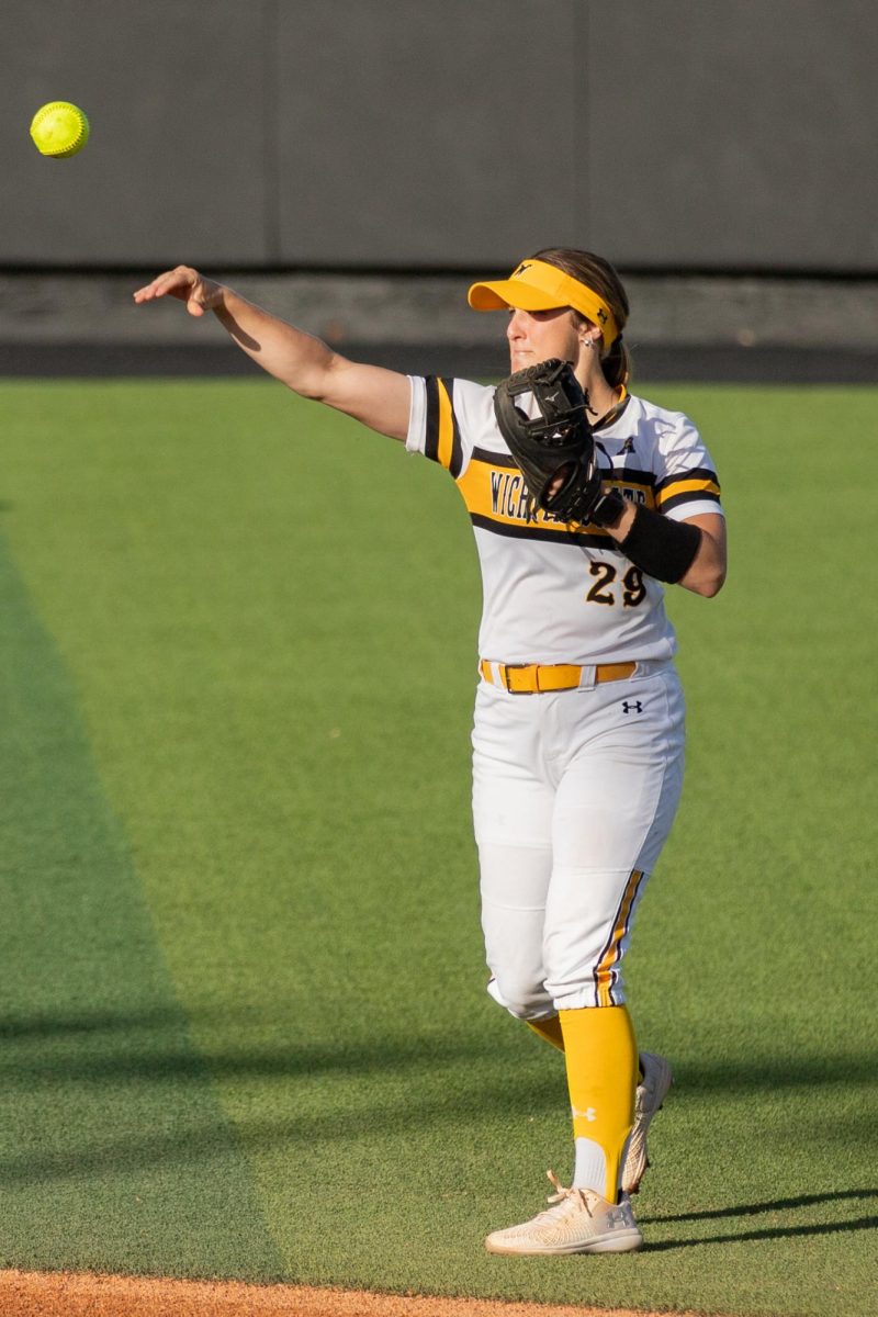Junior Taylor Sedlacek returns the ball to the pitching circle during the game against East Carolina University on April 11.