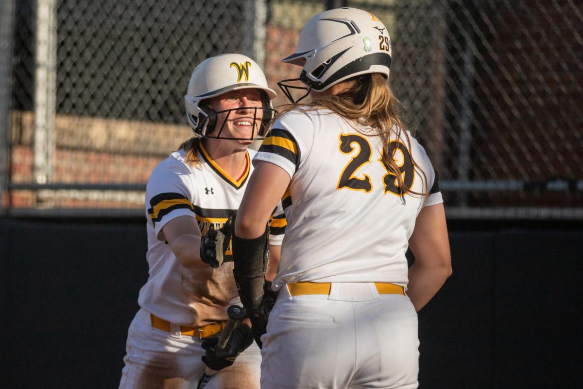 Graduate student Ellee Eck congratulates junior Taylor Sedlacek after a home run during the first game of a three-game series against East Carolina.
