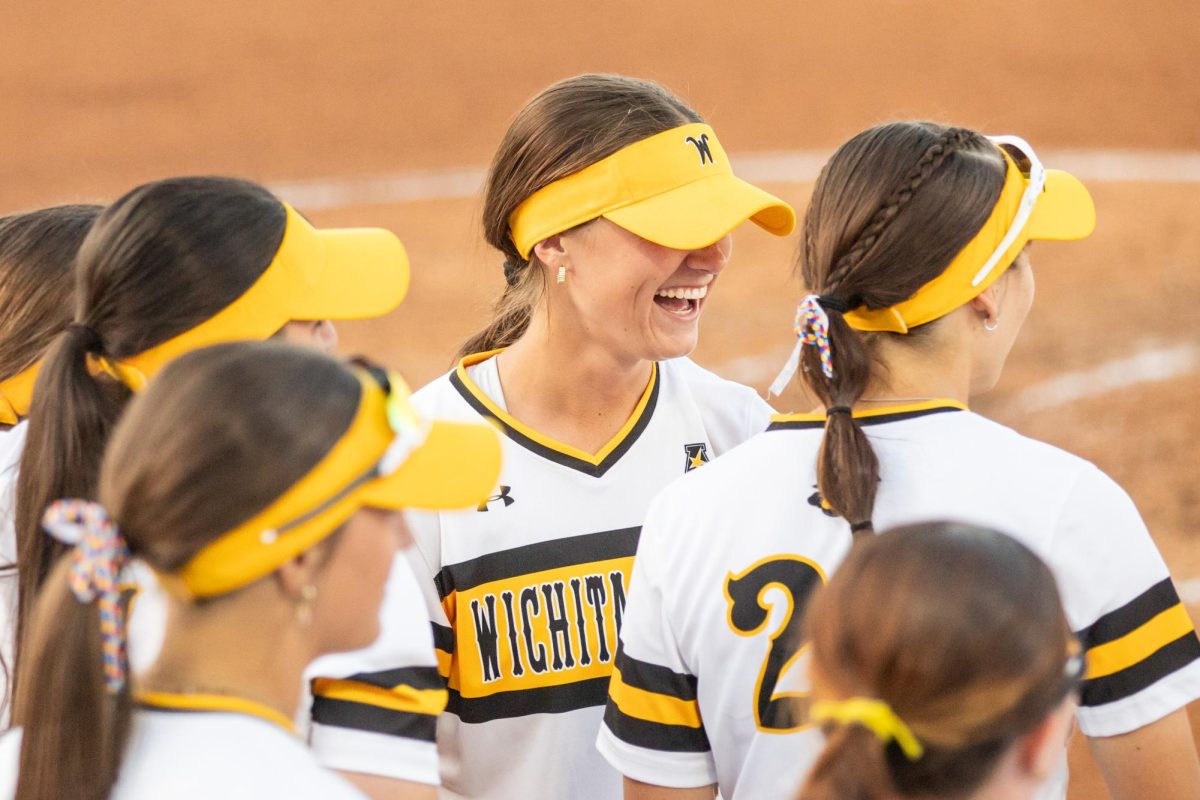 Senior Camryn Compton laughs with her teammates after a run-rule victory against the East Carolina Pirates on April 11.