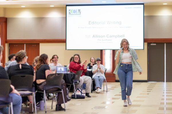 Allison Campbell walks up to accept her award in editorial writing during the 2024 Kansas Collegiate Media conference.