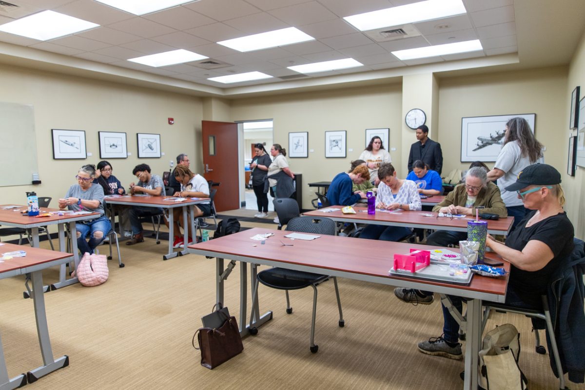 Members of the Indigenous Student Collective participate in a spiral stich beadwork class led by local beadworker Michelle Conine. The class was one of four hosted in the Rhatigan Student Center this semester in which participants could learn different beadwork styles.