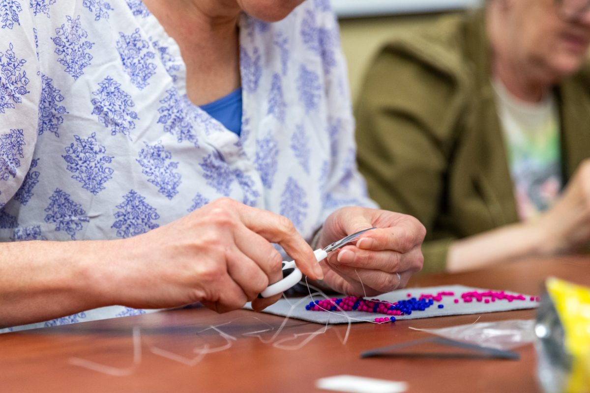 Moriah Beck, a chemistry and biochemistry professor, cuts a string on her spiral stitch bracelet. Beck and her friend, biological sciences Office Coordinator Marcia Norton, enjoy crafting together and attended the May 1 class held in the Rhatigan Student Center.