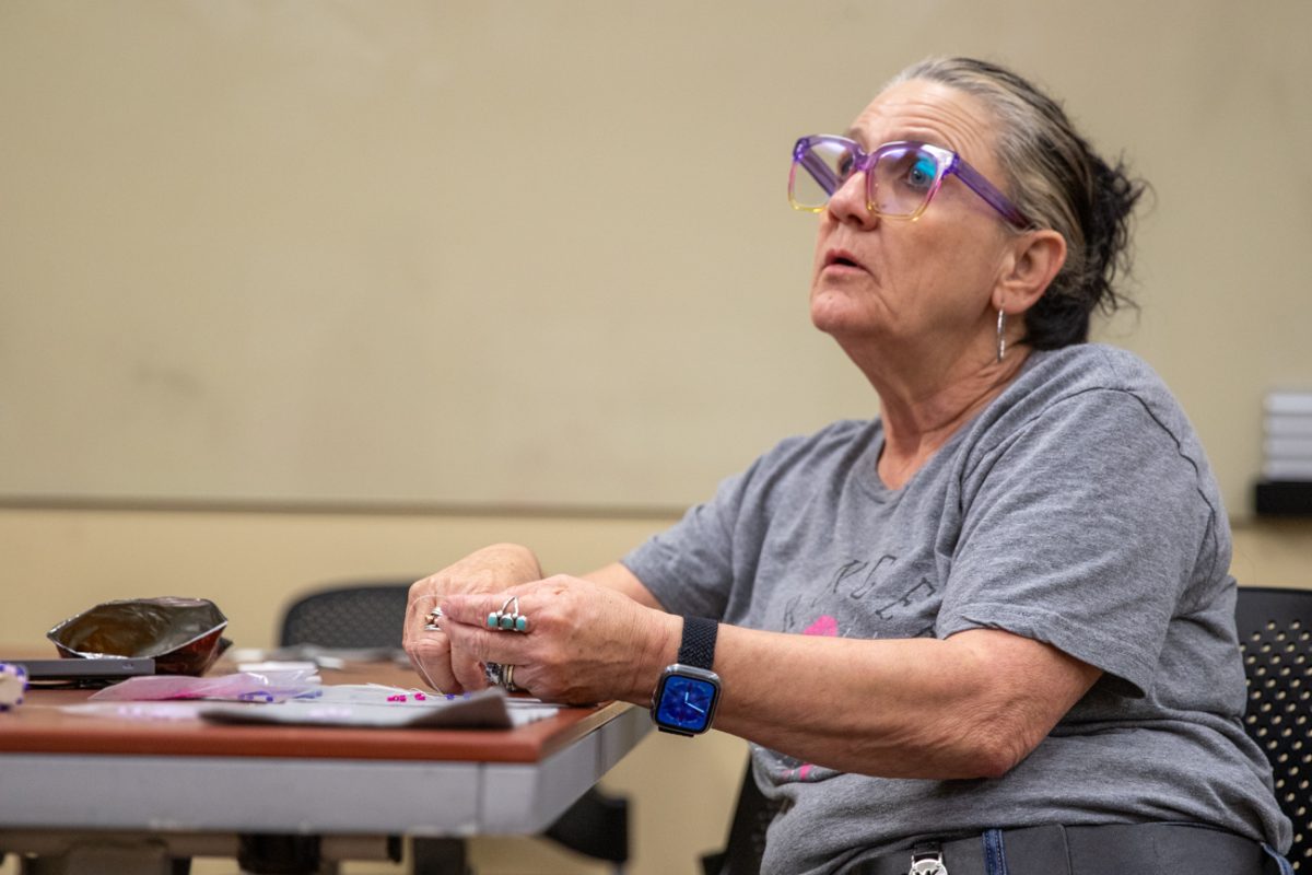 Lisa Oldham looks at beadworker Michelle Conine's projection of a spiral stitch during the Indigenous Student Collective's class on May 1. Oldham also brought her tubular peyote stitch from the last class, held on April 17.
