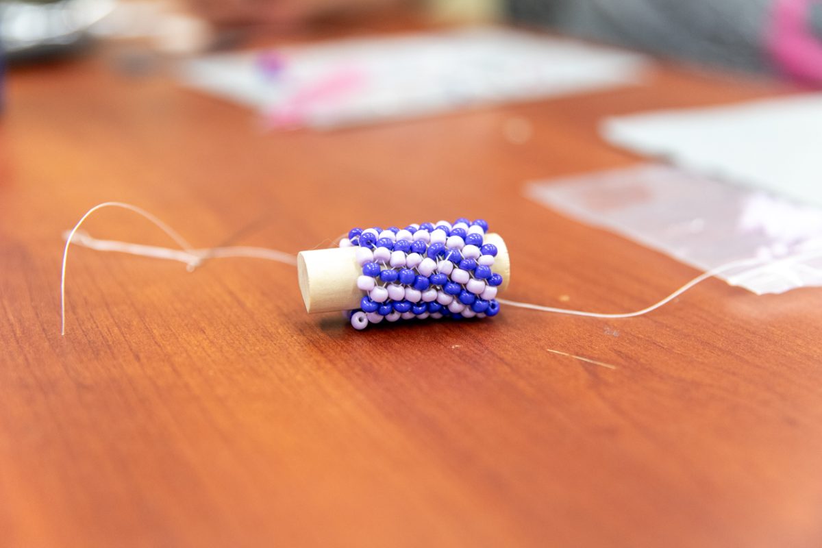 Lisa Oldham's peyote stitch sits on a table in room 258 in the Rhatigan Student Center while she works on her newest stitch, the spiral stitch. Oldham attended the previous Indigenous Student Collectve beadworking class as well as the one that was most recently held on May 1.
