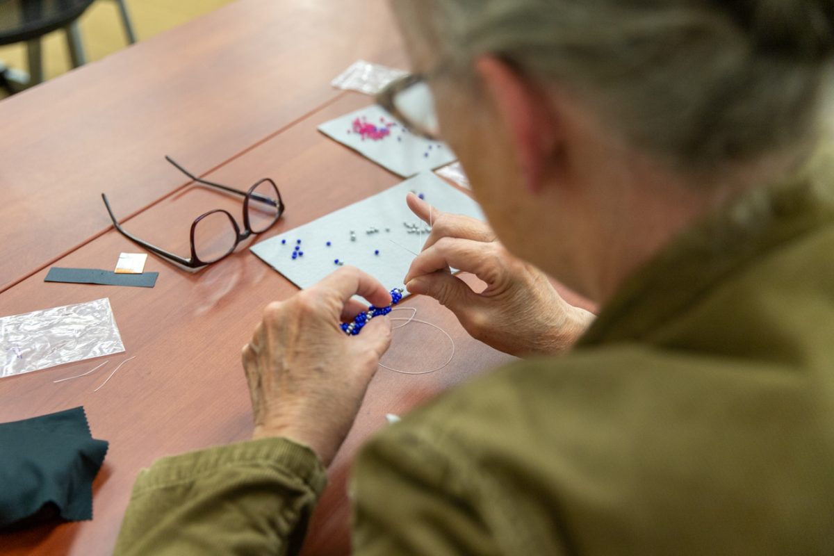 Marcia Norton, an office doordinator for the Department of Biological Sciences, works on her spiral stitch bracelet while attending the ISC's beadworking event. The class was held on May 1 and taught by local beadworker Michelle Conine.