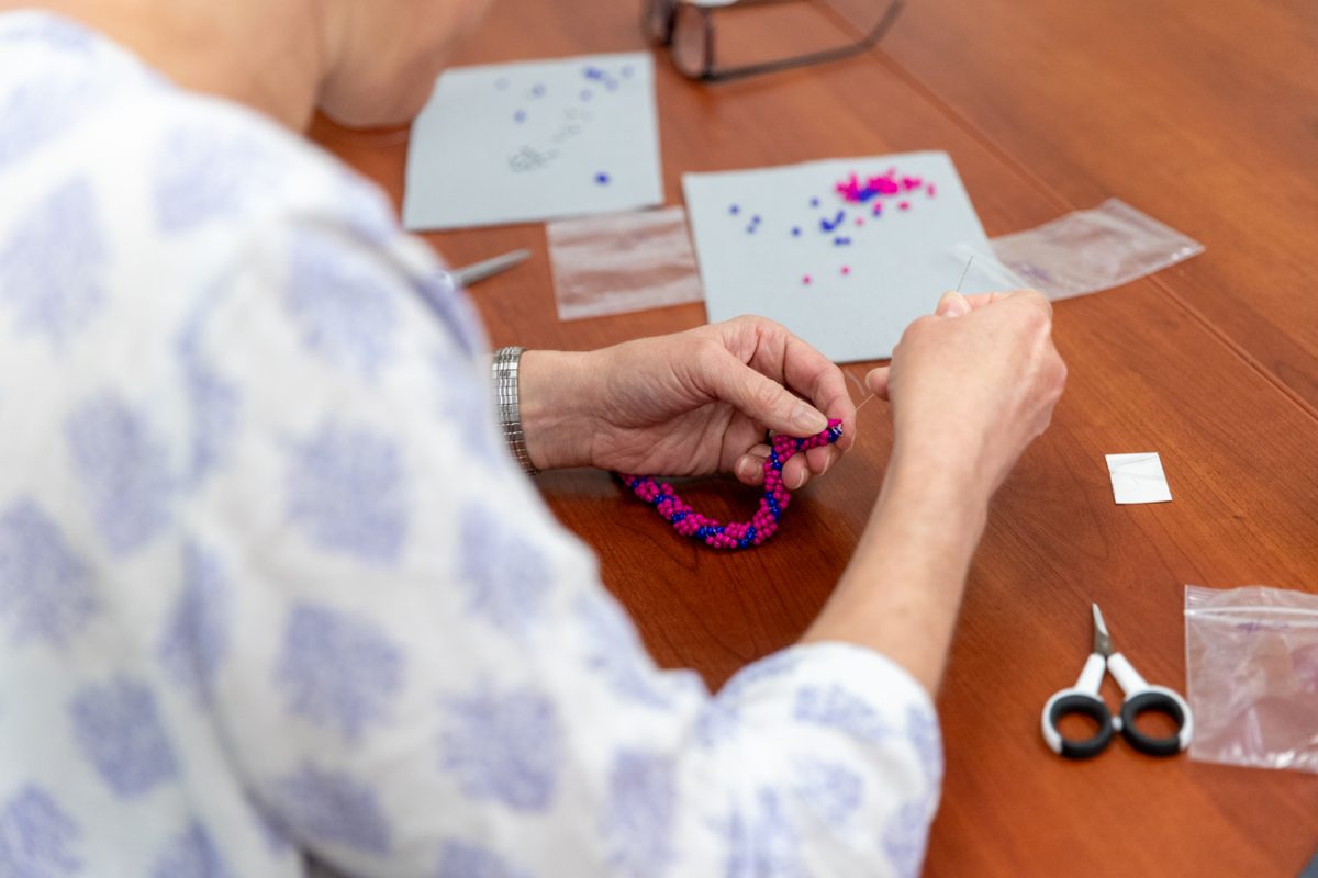 Moriah Beck, a chemistry and biochemistry professor, works on her spirial stitch bead bracelet during the Indigenous Student Collective's class on May 1. The class was one of four hosted by the  ISC over the last semester.