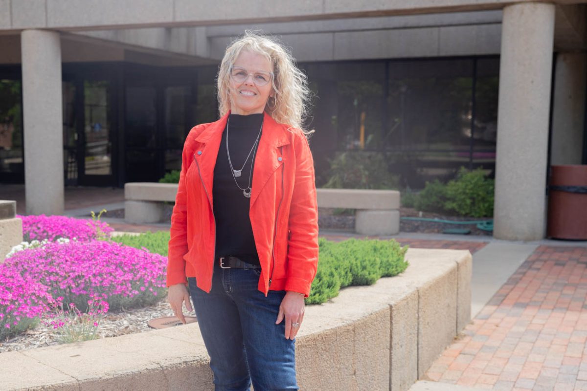 Social work student Robin Monroe poses for a photo outside Ablah Library. Monroe, an adult learner studying social work, said she spends a lot of time in the library studying as she finishes her bachelor's degree. 