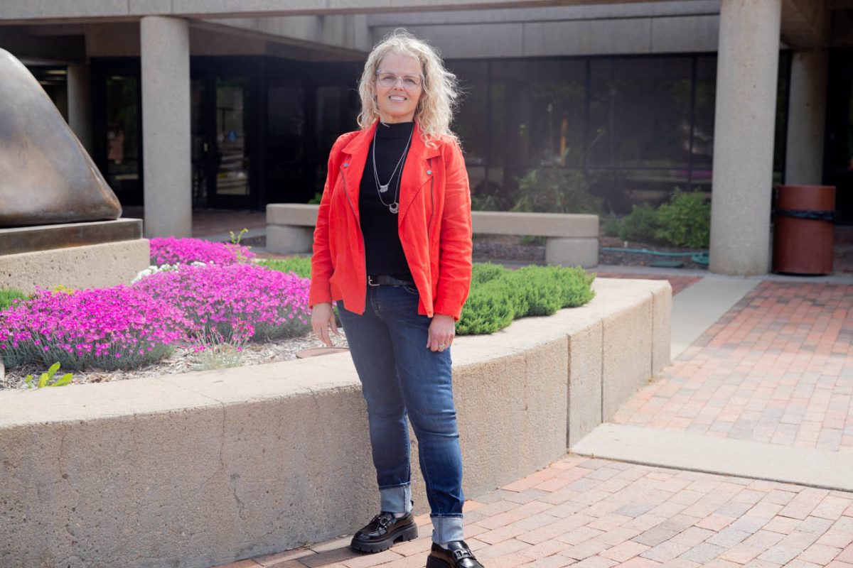 Social work student Robin Monroe poses for a photo outside Ablah Library. Monroe, an adult learner studying social work, said she spends a lot of time in the library studying as she finishes her bachelor's degree. 